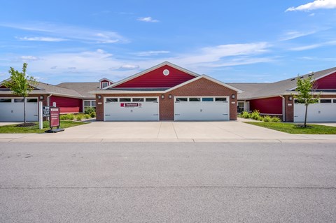 A red building with a white garage door in front.