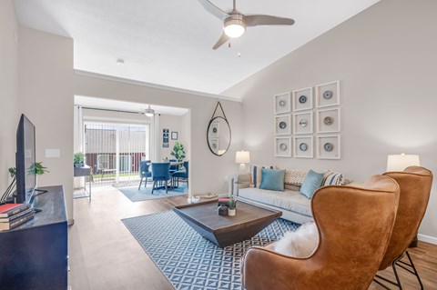 A living room with a brown leather chair and a blue patterned rug.