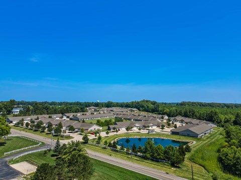 A bird's eye view of a residential area with a swimming pool.
