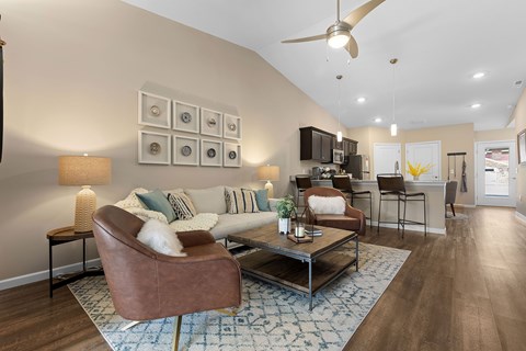 A living room with a brown leather couch and a coffee table.