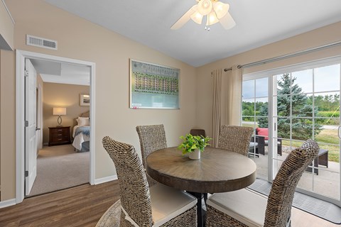 A dining room with a round table and chairs.