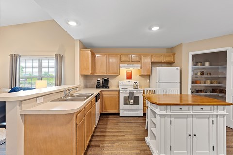 A kitchen with wooden cabinets and a white refrigerator.