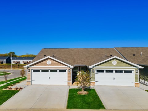 A house with two garages and a driveway.