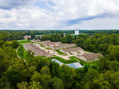 A bird's eye view of a residential area with houses surrounded by trees.