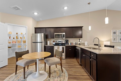A kitchen with brown cabinets and a white refrigerator.