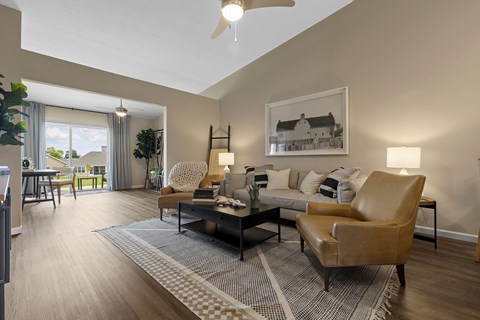 A living room with a brown leather chair and a grey and white rug.