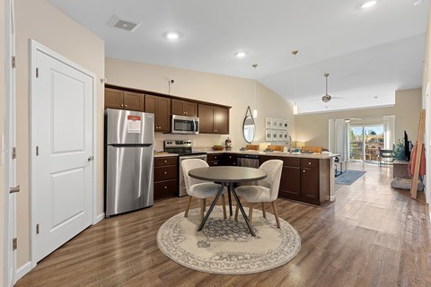A kitchen with a table and chairs in the middle of the room.