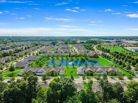 A bird's eye view of a residential area with a large swimming pool.