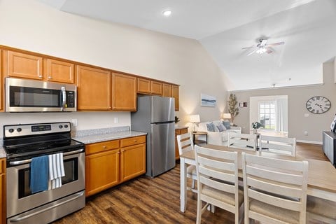 A kitchen with wooden cabinets and a stainless steel oven.