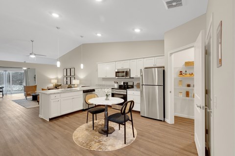 A modern kitchen with a dining table and chairs.