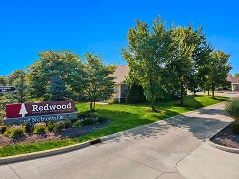 A sign for Redwood of Noblesville is in front of a building.