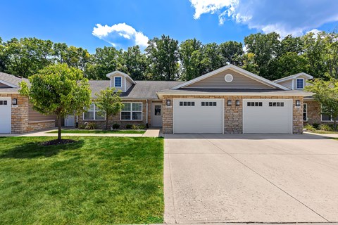 A large house with a driveway in front.