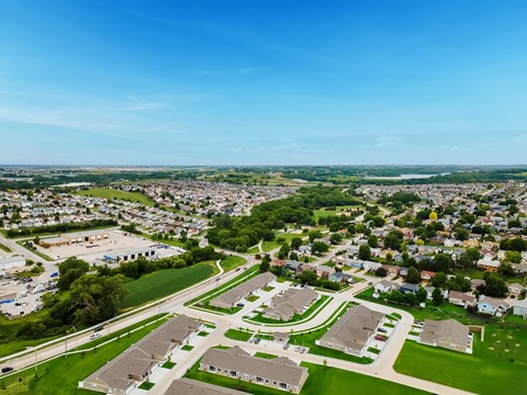 A bird's eye view of a residential area with houses and green spaces.