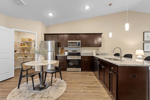 A kitchen with brown cabinets and a white fridge.