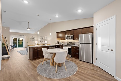 A modern kitchen with a dining table and chairs.