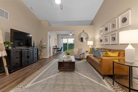 A living room with a brown sofa and a coffee table.