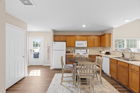 A kitchen with wooden cabinets and a white refrigerator.