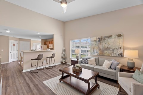 A living room with a brown coffee table and a white couch.