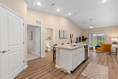 A kitchen with white cabinets and a large island.