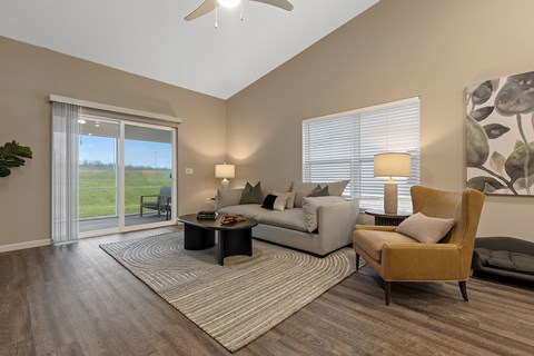A living room with a sofa, armchair, and a coffee table.