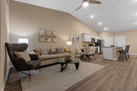 A living room with a brown couch and a black coffee table.