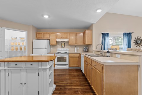 A kitchen with wooden cabinets and a white refrigerator.