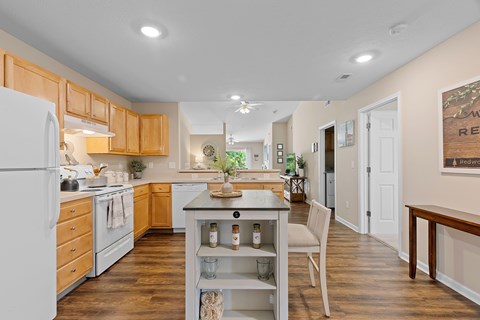 A kitchen with wooden cabinets and a white refrigerator.
