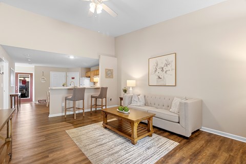 A living room with a couch, chairs, and a coffee table.