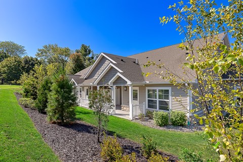 A house with a grey roof and a white porch.