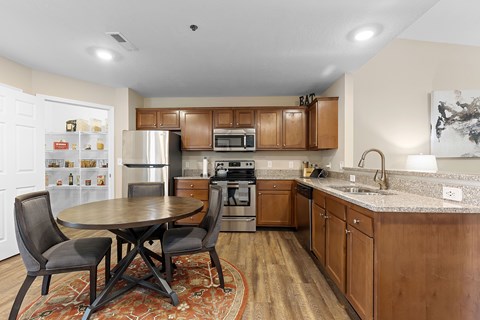 A kitchen with a table and chairs in the middle of the room.