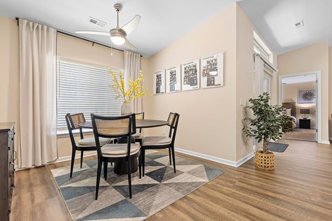 A dining room with a table and chairs.