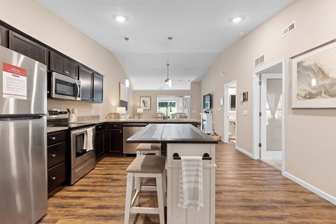 A kitchen with a table and chairs in the middle of it.