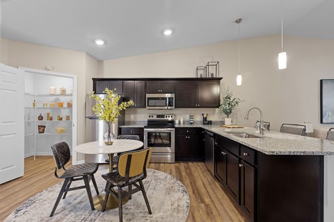A modern kitchen with a dining table and chairs.