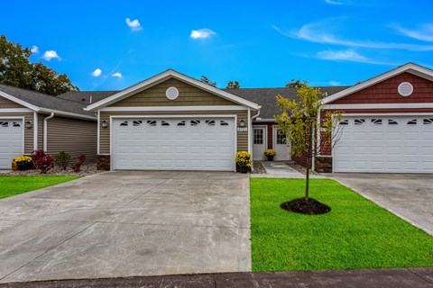 A house with a brown roof and a white garage door.