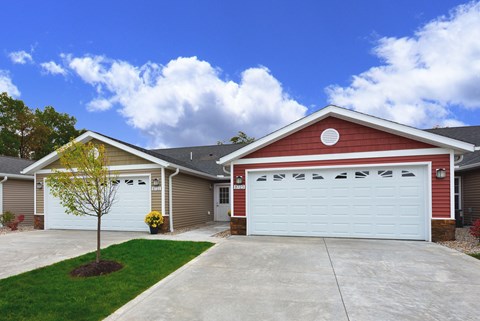 A red house with a white garage door.