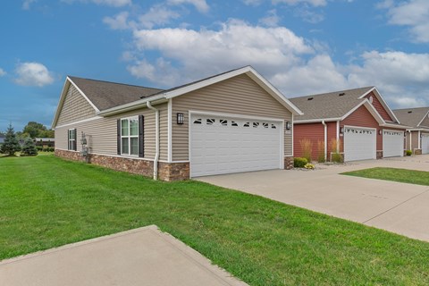 A row of houses with garages and driveways.