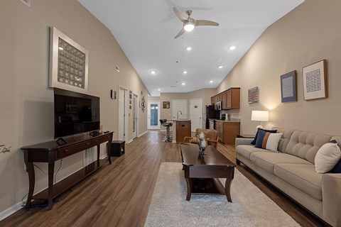 A living room with a brown couch and a wooden coffee table.