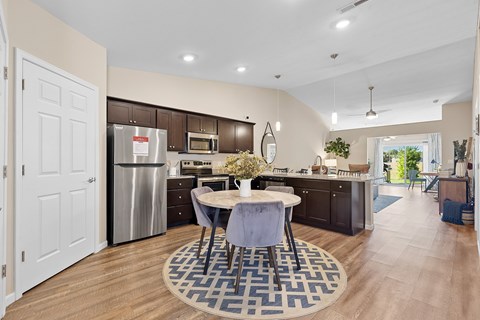A kitchen with a table and chairs in the middle of the room.
