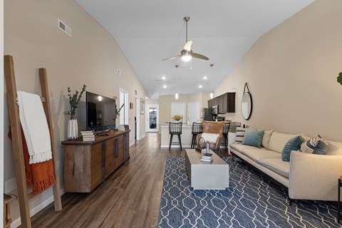 A living room with a white couch and a wooden cabinet.