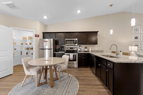 A modern kitchen with a table and chairs.