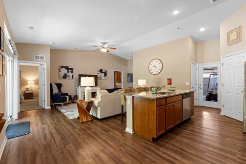 A living room with a white couch and a wooden floor.