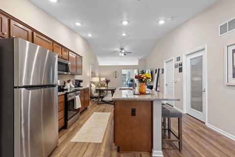 A modern kitchen with a large island and stainless steel appliances.