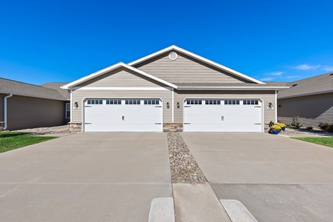 A two-car garage with a stone border in front.