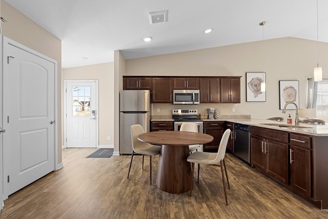 A kitchen with brown cabinets and a white fridge.