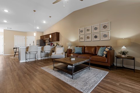 A living room with a brown leather couch and a coffee table.