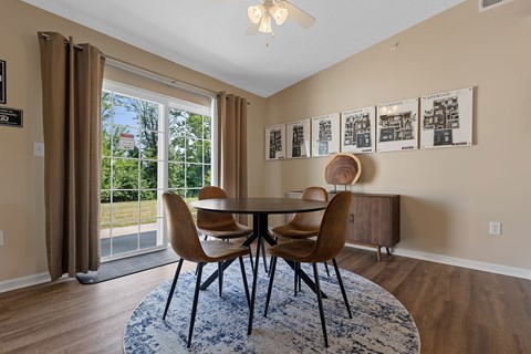 A dining room with a table and chairs.