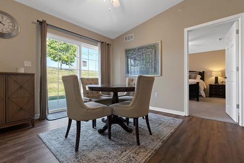 A dining room with a table and chairs.
