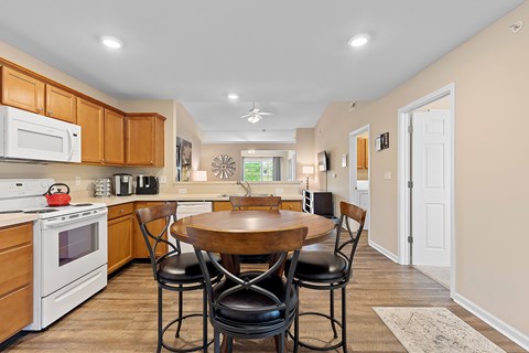 A kitchen with a table and chairs in the middle of the room.