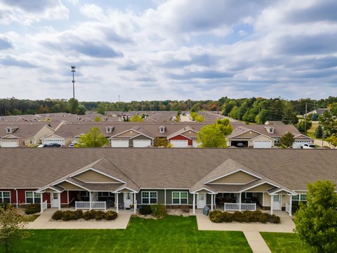 A row of houses with a grassy front yard.