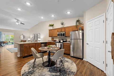 A modern kitchen with a dining table and chairs.